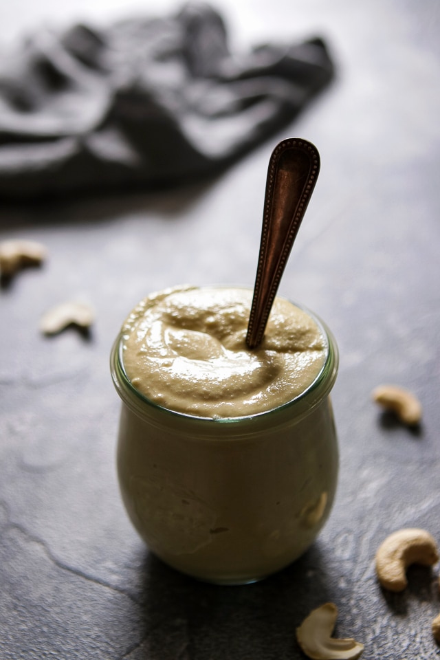 Vegan Cashew Mayo in a Jar with a Spoon right in the middle of the sauce