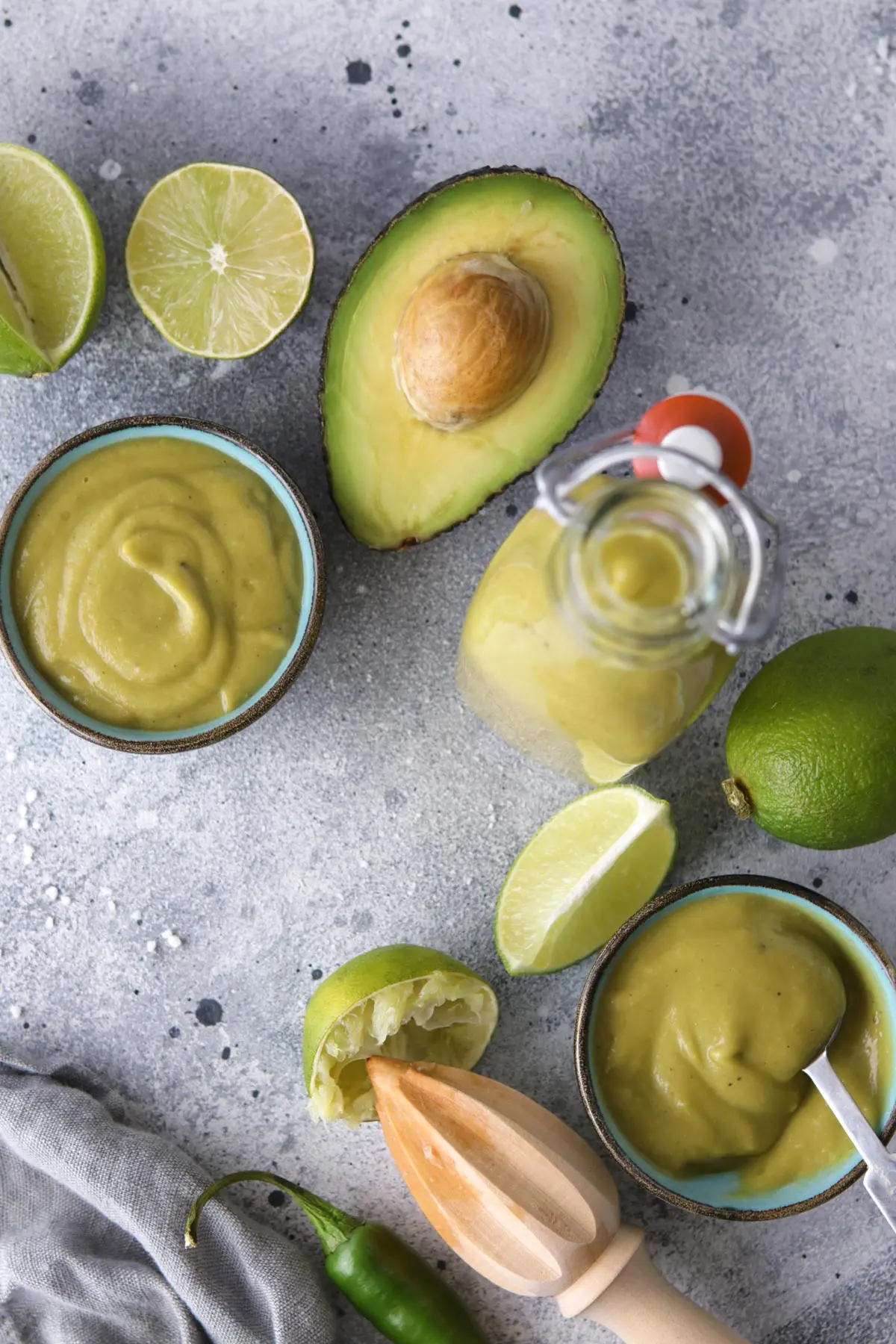 Avocado Sauce in Small Bowls Surrounded by Ingredient Props