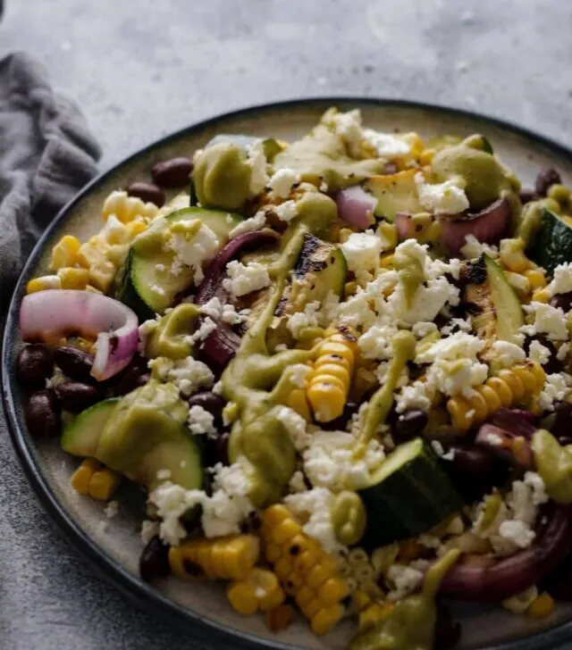 cropped-Grilled-Zucchini-and-Corn-Salad-with-Black-Beans-on-a-Plate-on-a-Grey-Background.jpg
