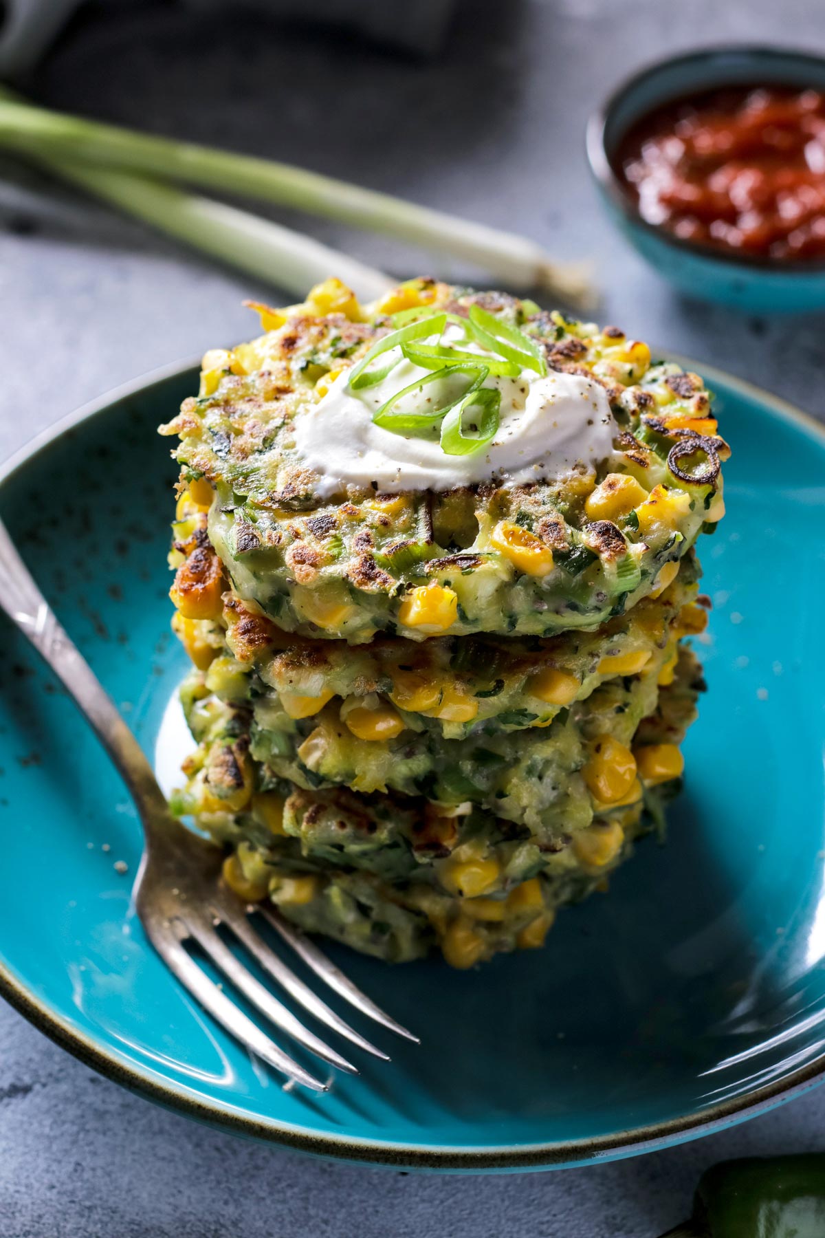 Vegan Zucchini Corn Fritters Stalked on a Plate.
