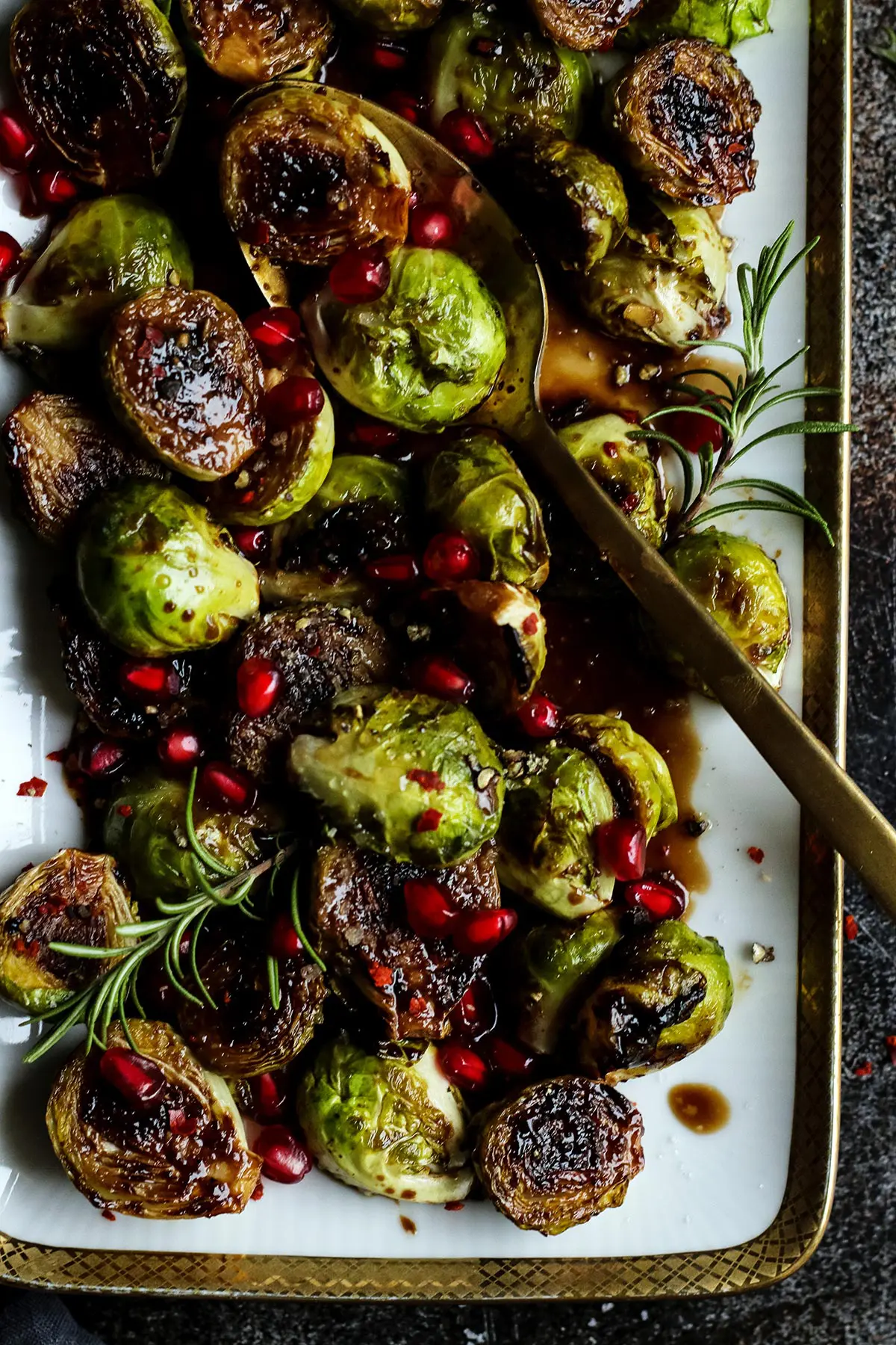 A Closeup of a Vegan Holiday Brussels Sprouts Side Dish with a Serving Spoon.