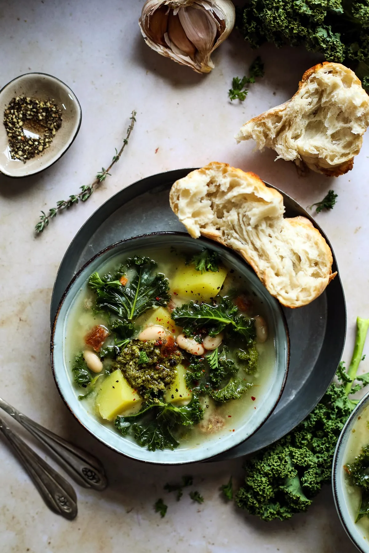 Kale Tuscan soup in a bowl with bread.