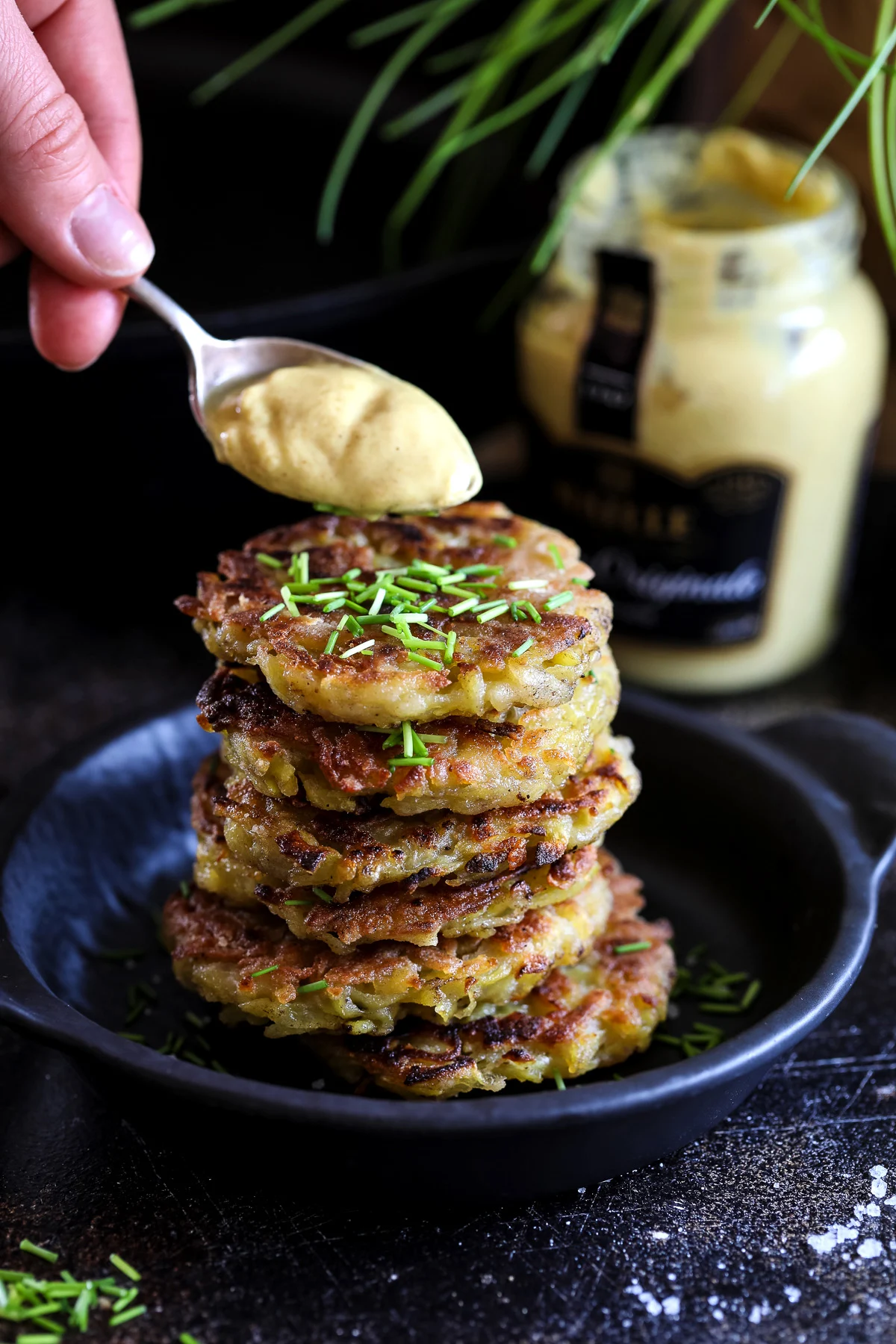 Adding Mustard to a Stack of Potato Pancakes.