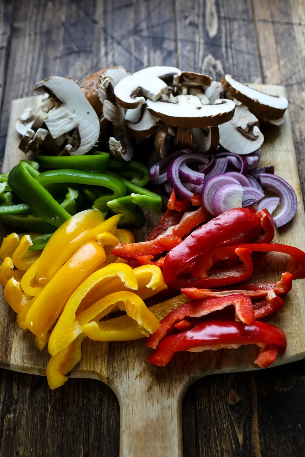 Cut peppers, onions and mushrooms on a cutting board