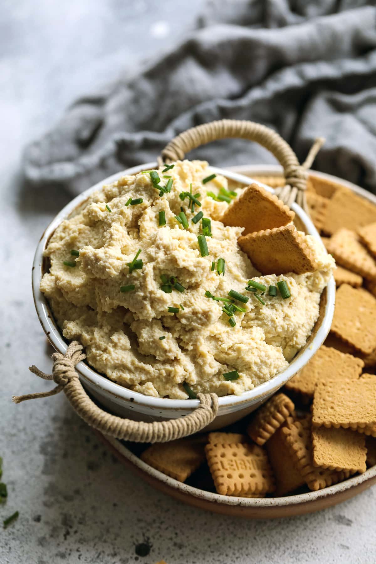 Vegan tofu ricotta in a bowl with crackers.