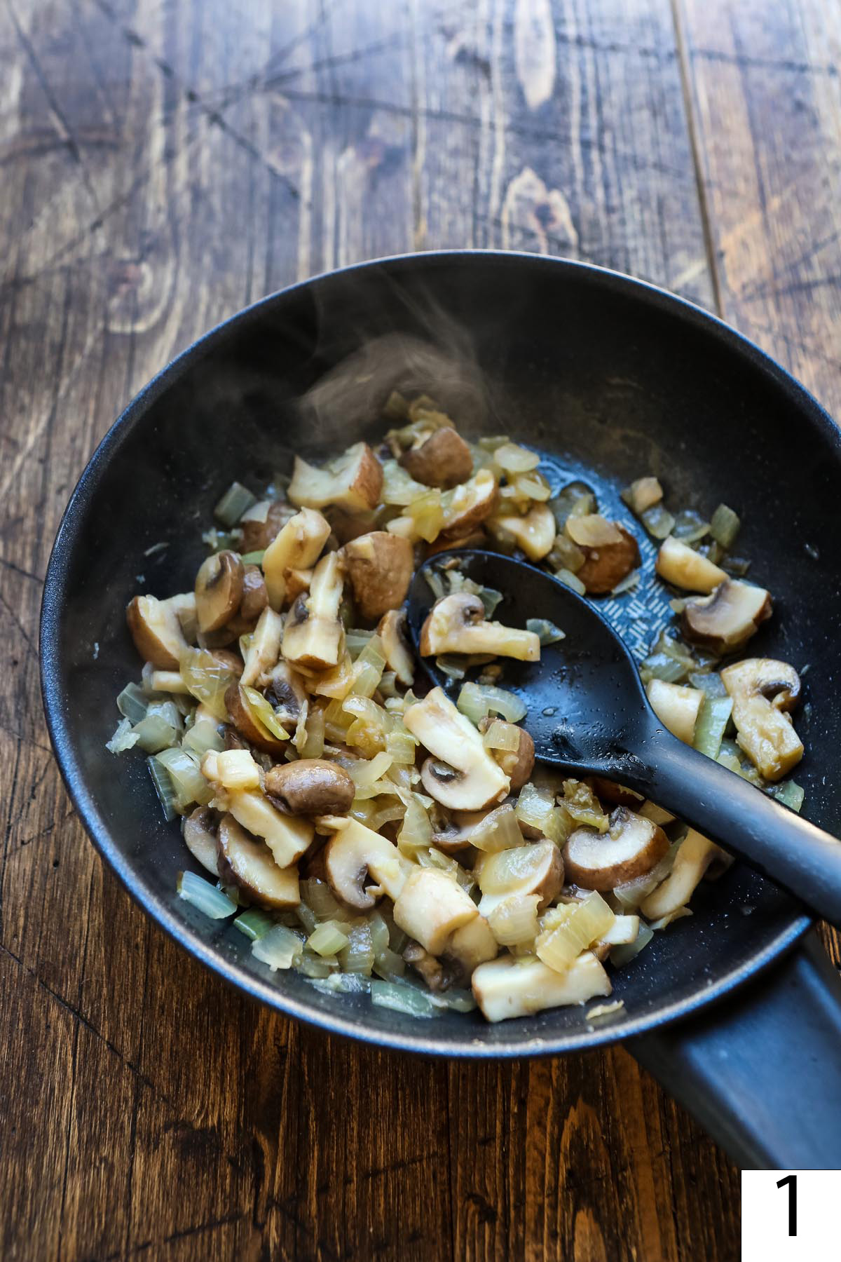 Sauteed mushroom with onions in a pan.