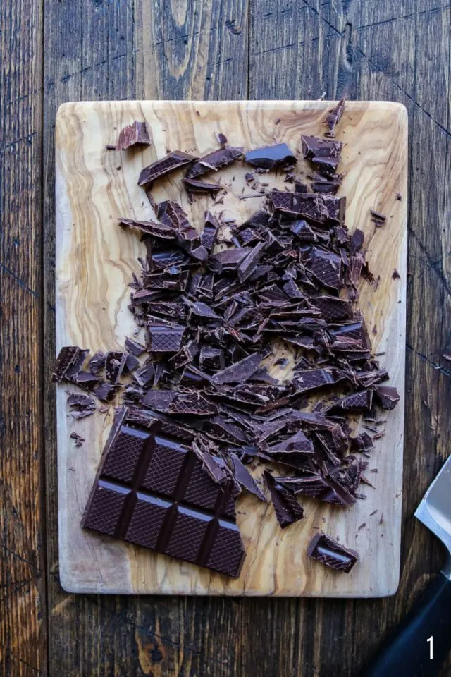 Chopping chocolate with a knife.