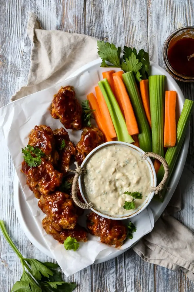 Vegan buffalo wings with blue cheese dip and veggie sticks.