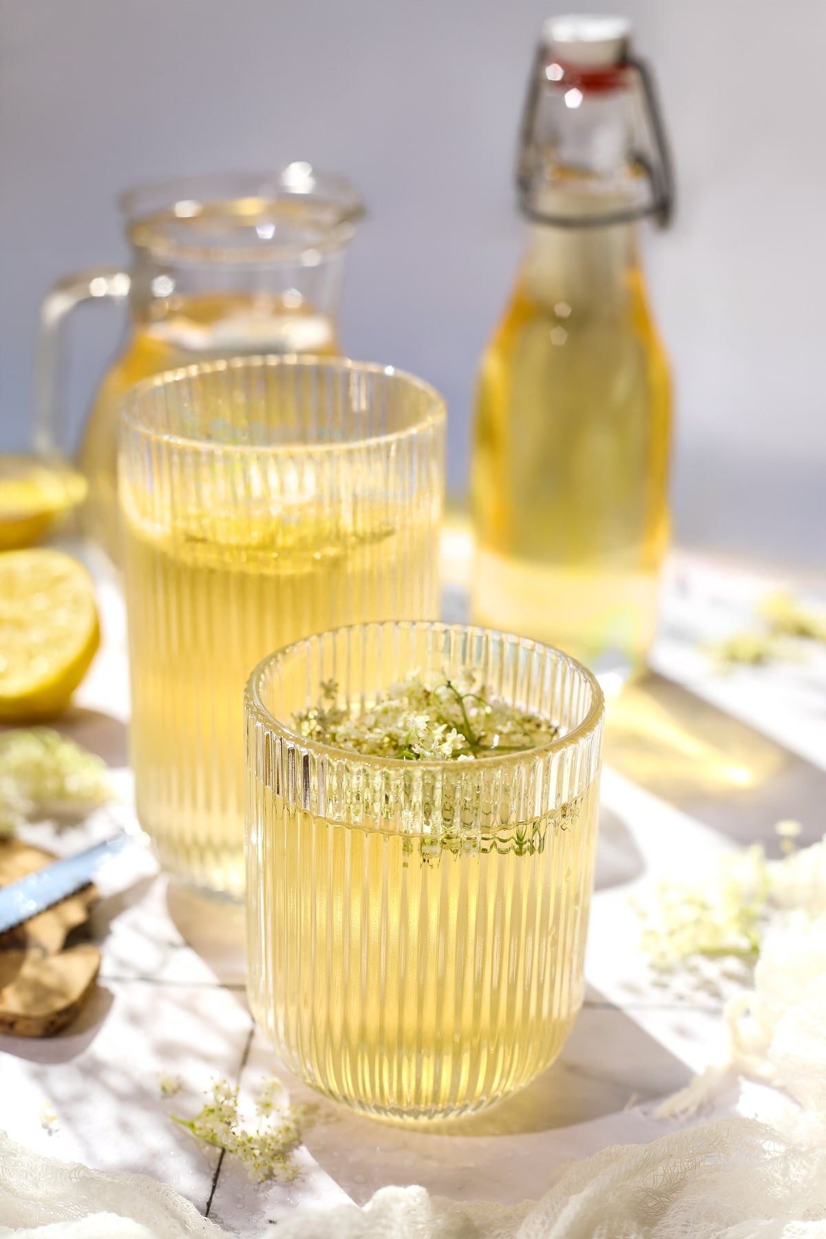 A glass of elderflower lemonade being served.