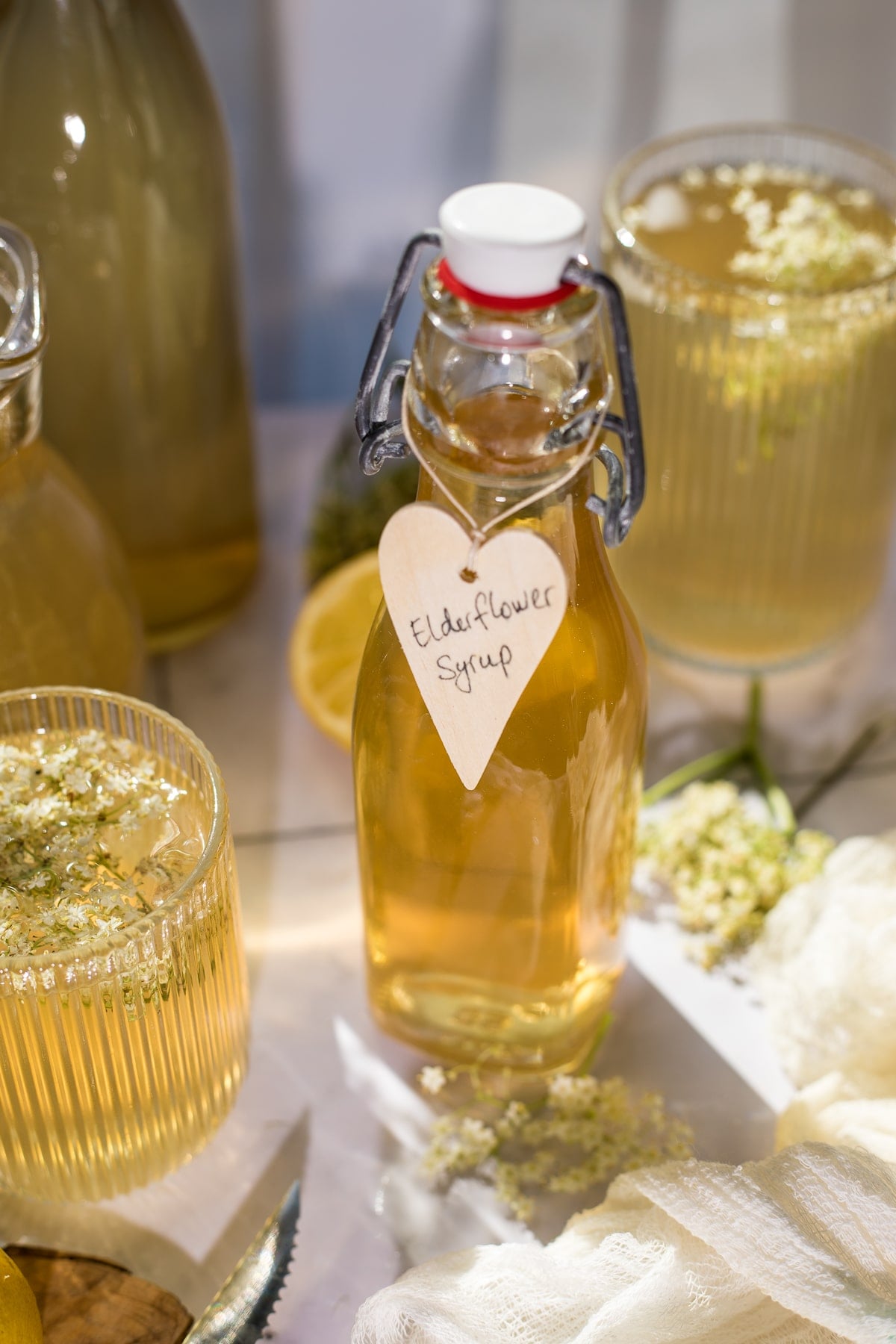 Elderflower cordial poured into a bottle.