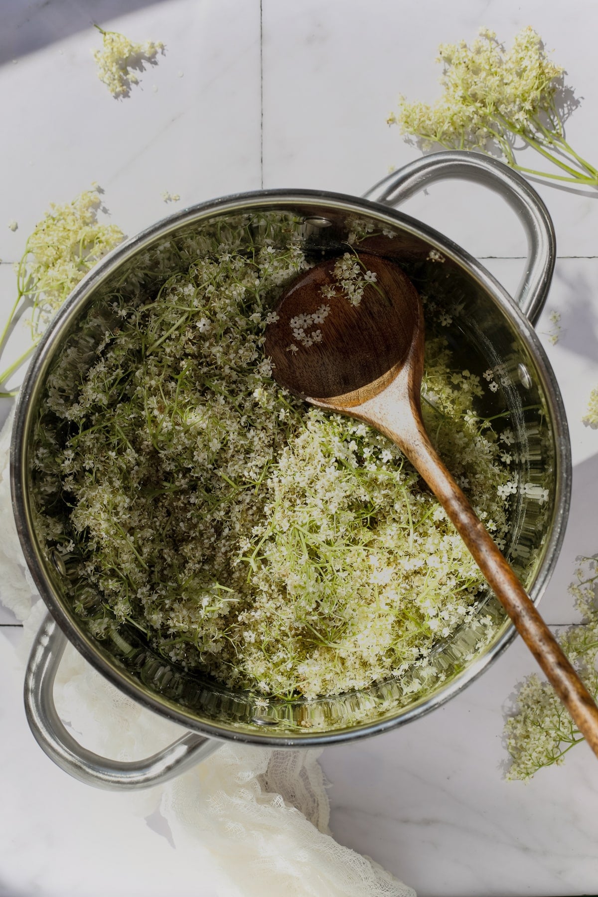 Elderflowers simmering in water with lemon juice.