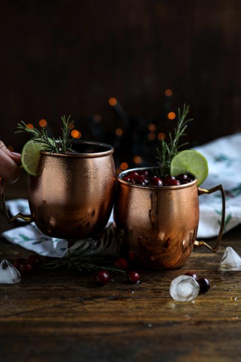Two Mugs of Moscow Mule on a Wooden Table